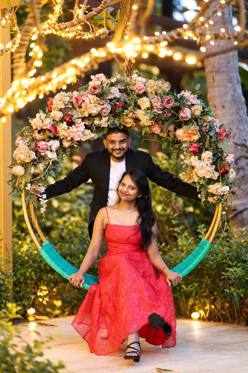 Sameer and Tanusree under a floral ring at twilight